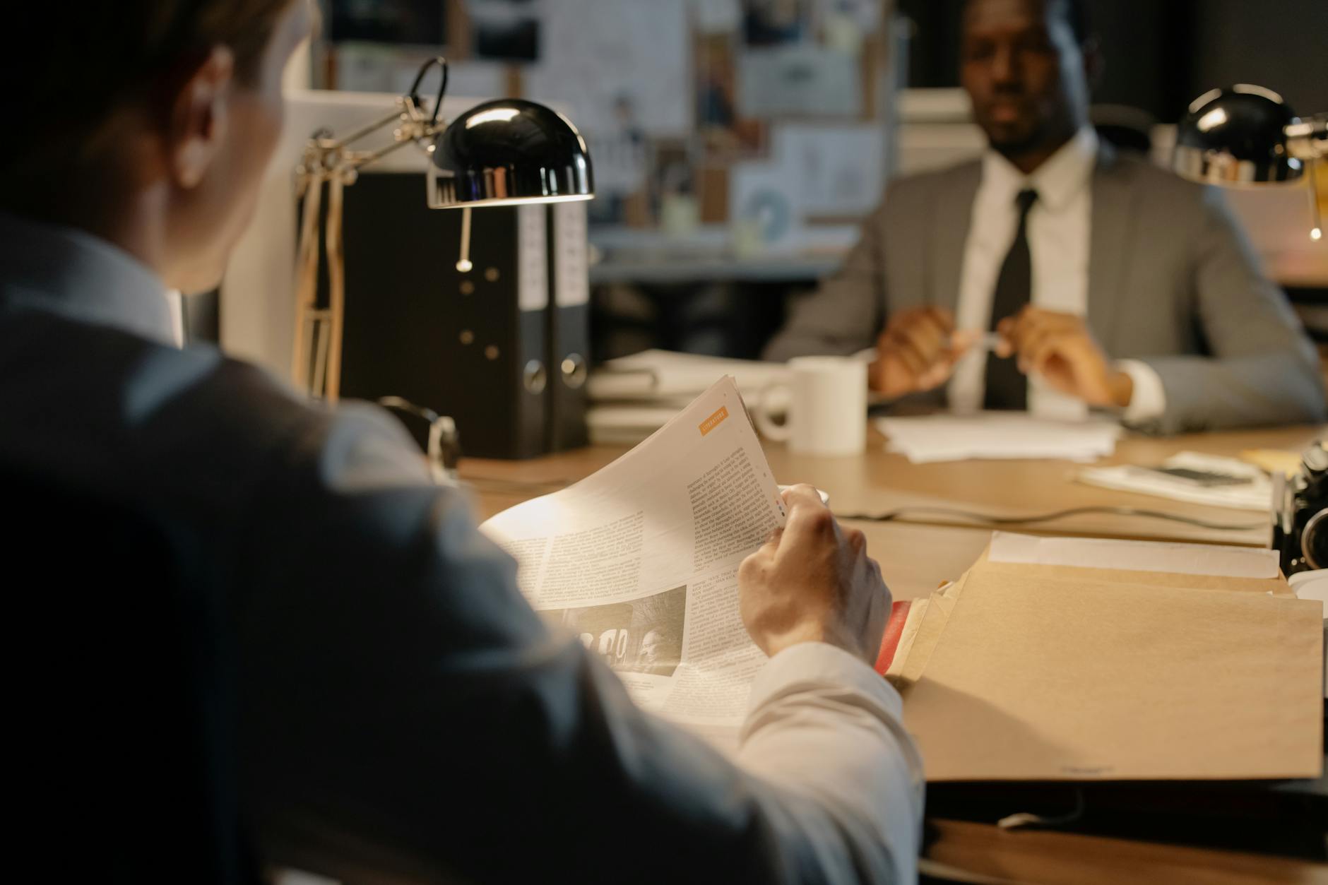 Professional office environment with documents and files representing federal investigation activities