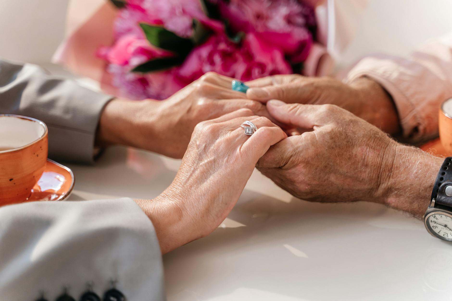 Two elderly hands reaching toward each other, symbolizing the emotional reunions between separated Korean families