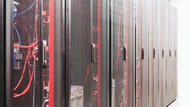 Modern data center server room with rows of network equipment and blue lighting