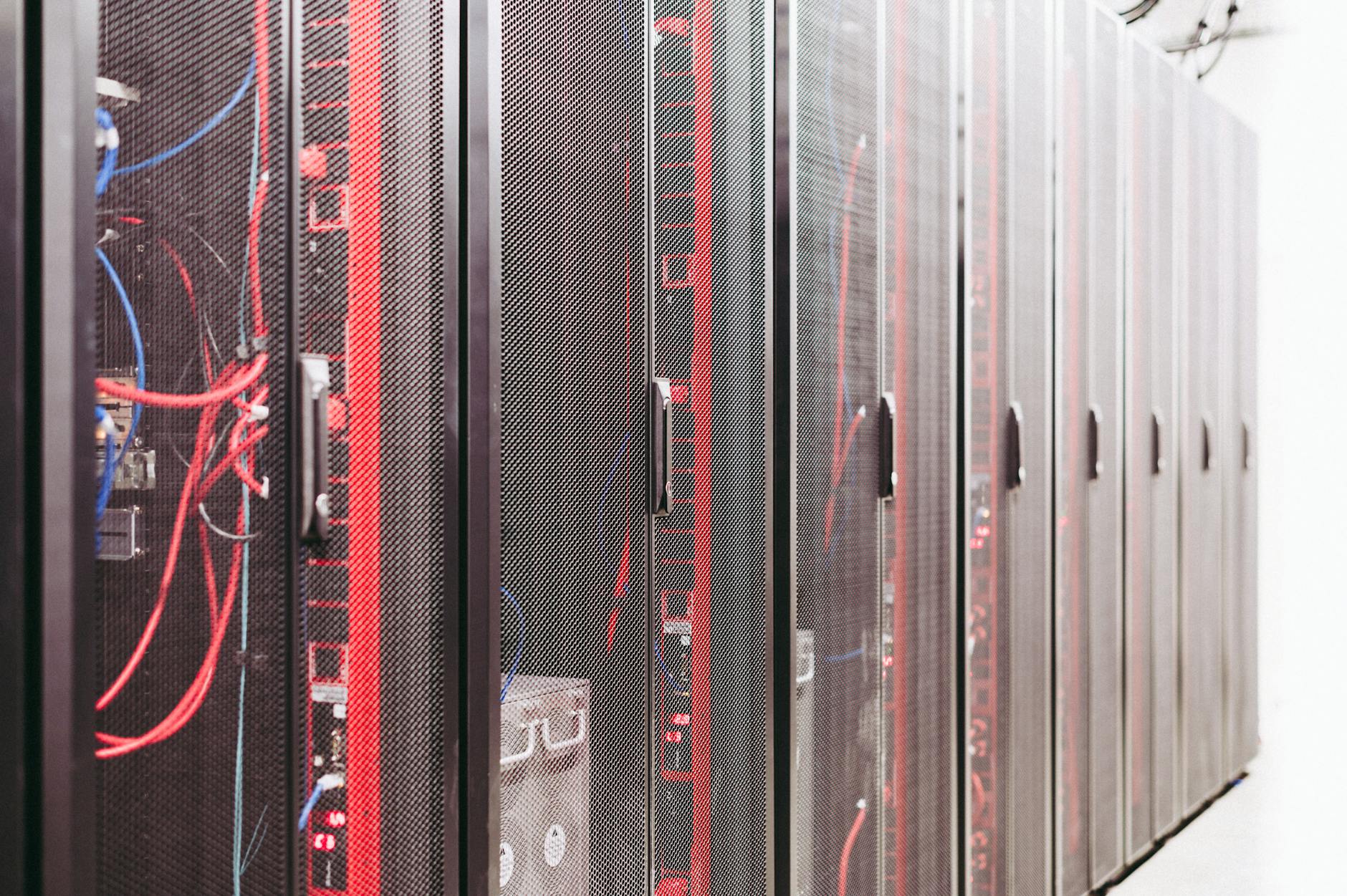 Modern data center server room with rows of network equipment and blue lighting
