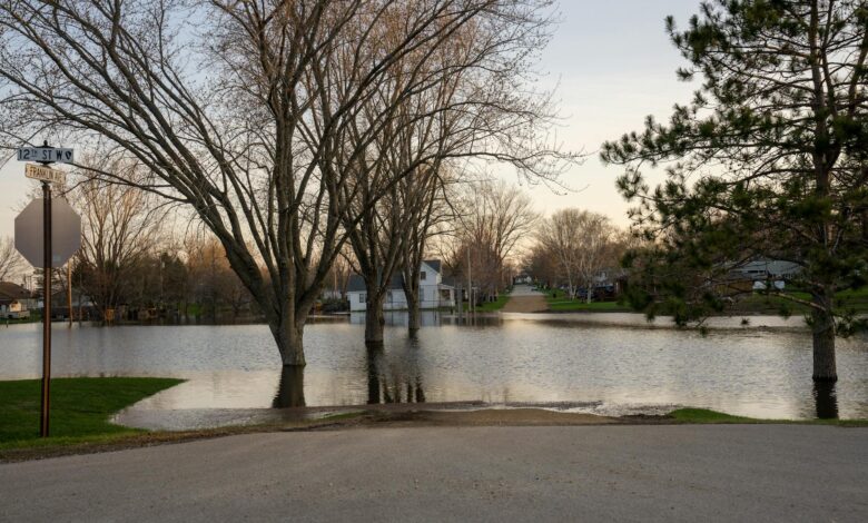Flooded residential area with water covering streets and reaching building foundations