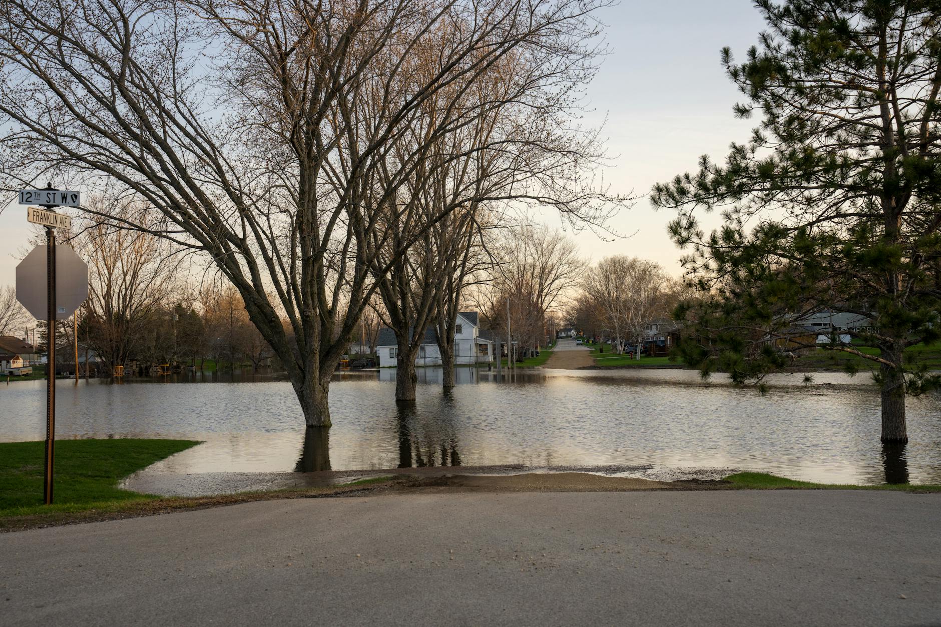 Flooded residential area with water covering streets and reaching building foundations