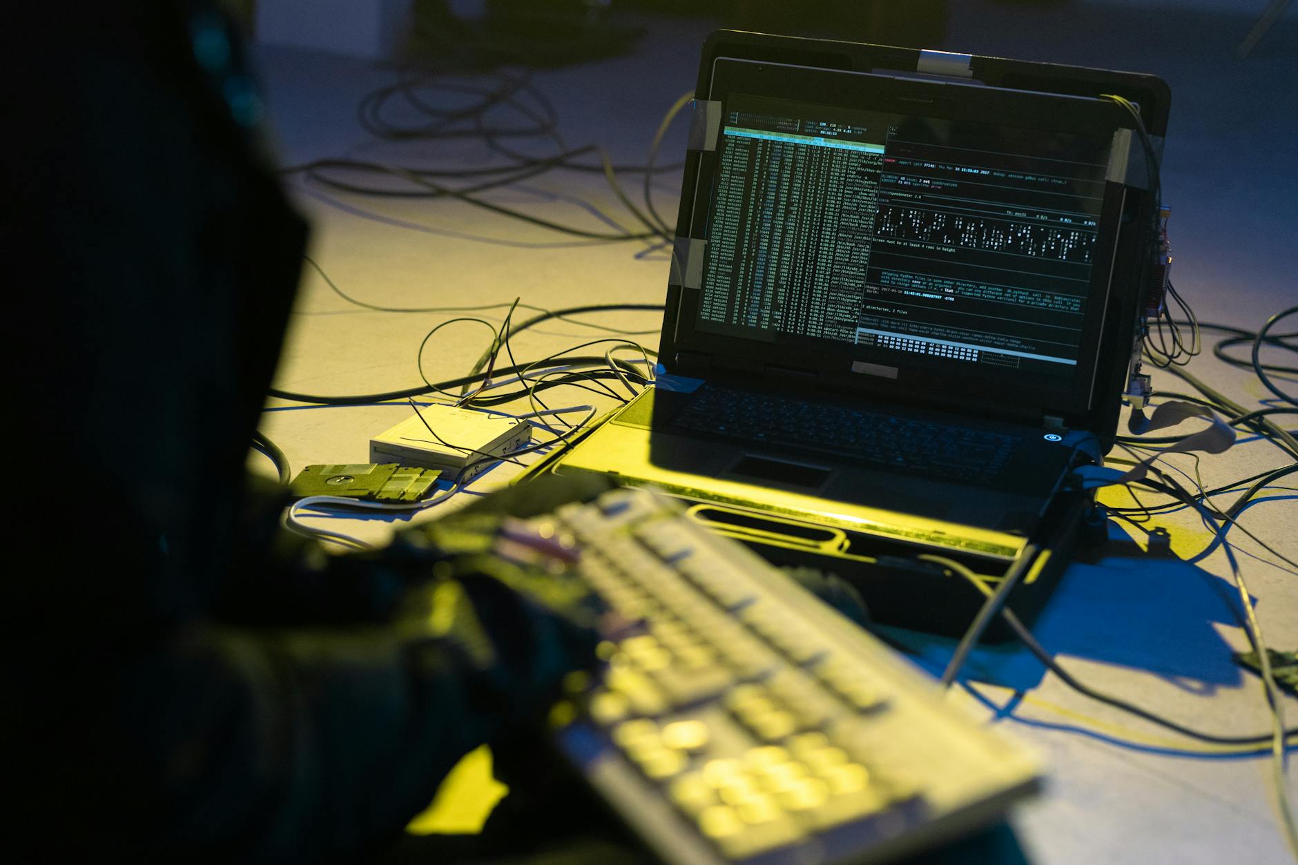 Cybersecurity professional monitoring network security systems on multiple computer screens