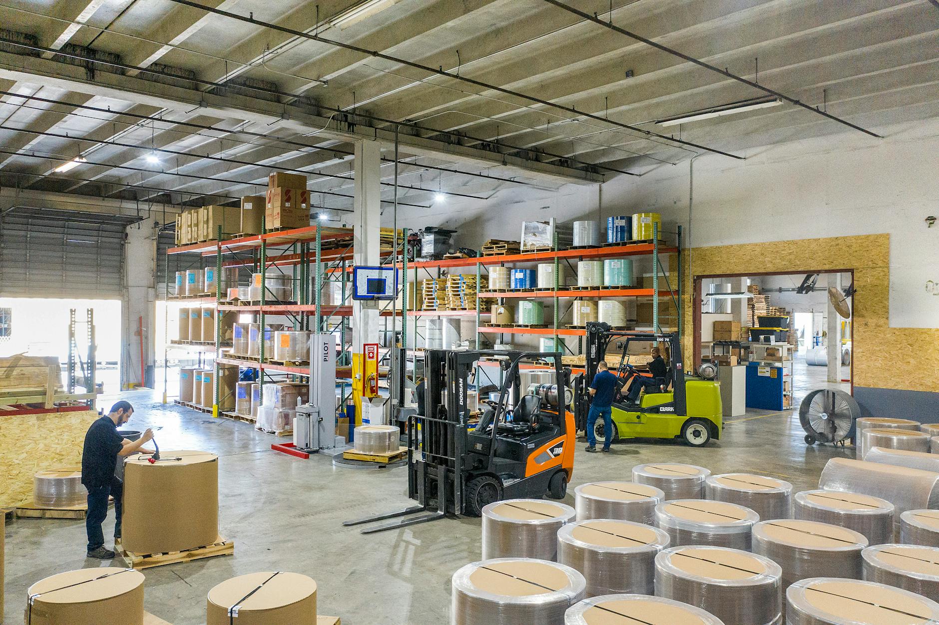 Large warehouse interior with high shelves and shopping carts, representing wholesale retail environment