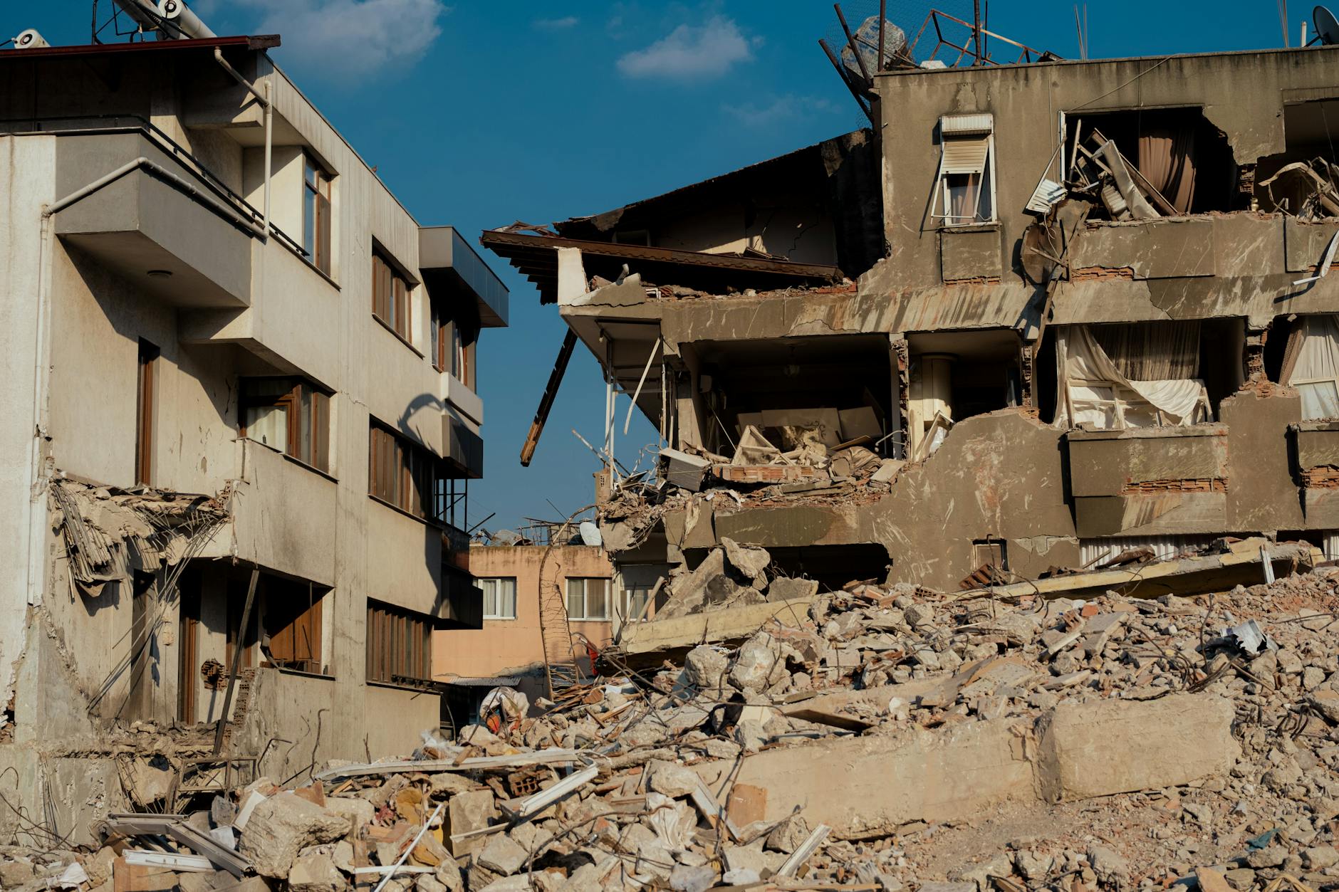 Damaged building structure showing cracks and debris from seismic activity