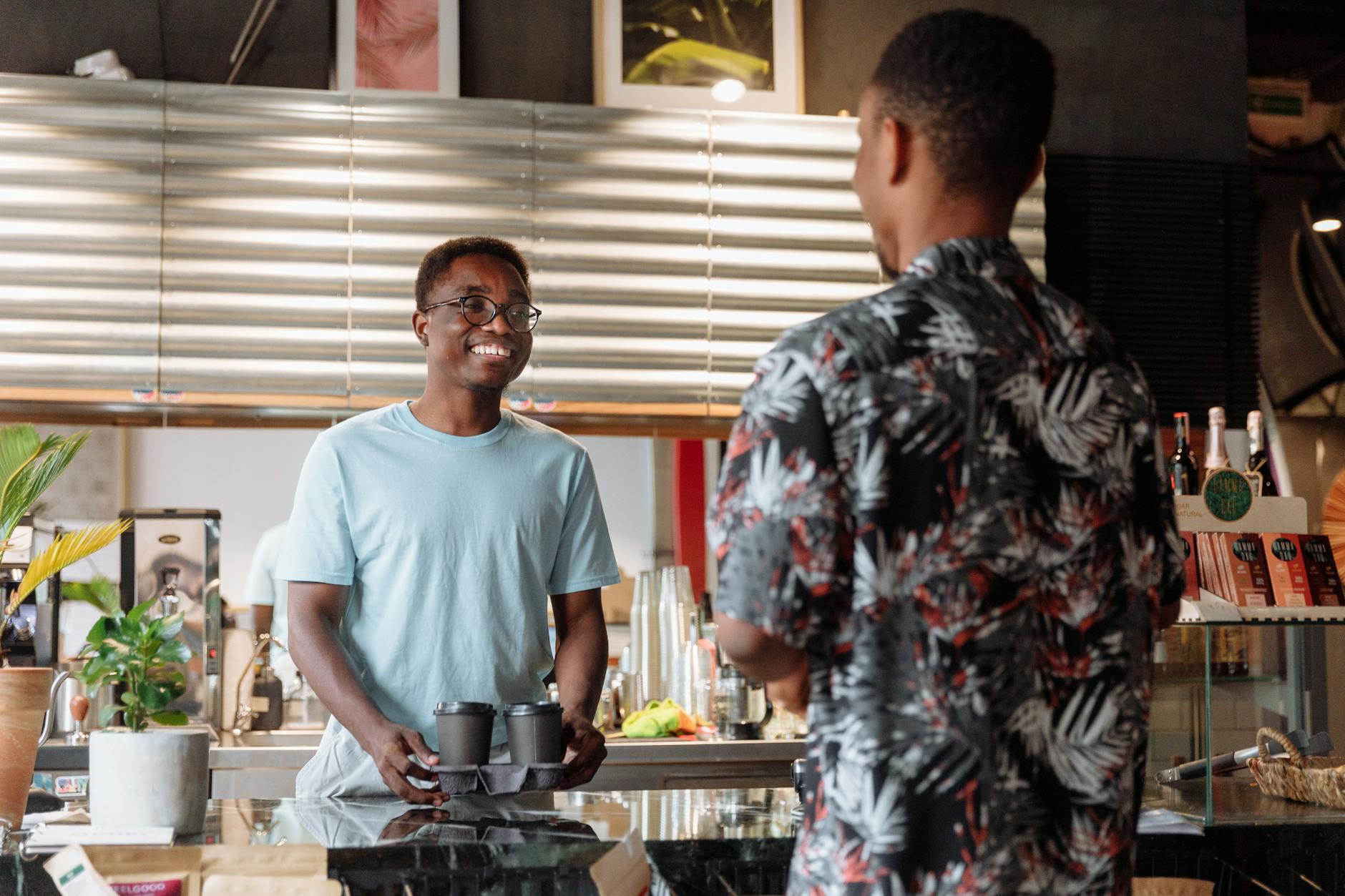Customers waiting in line at busy coffee shop counter
