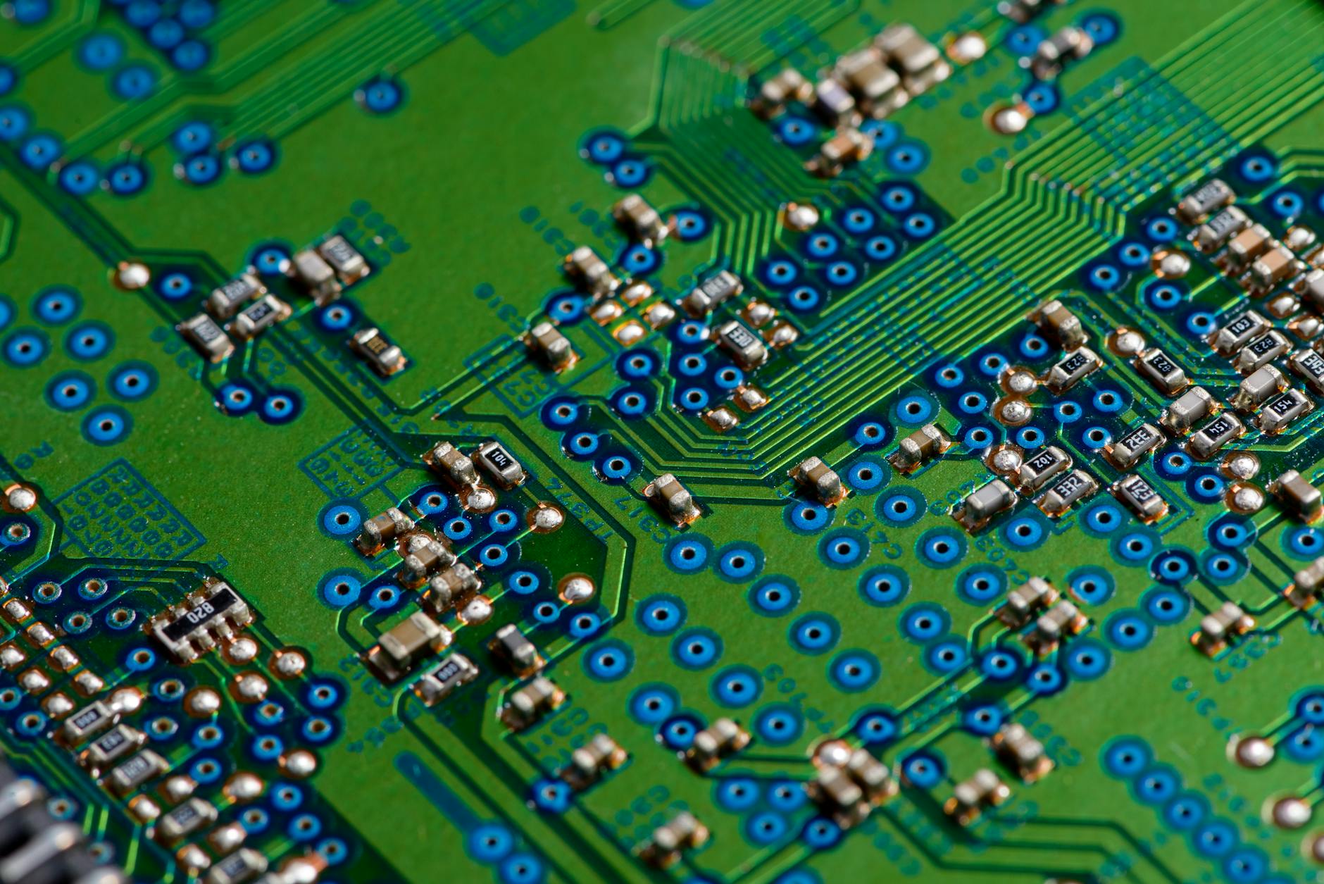 Modern electronics manufacturing facility with workers assembling electronic components