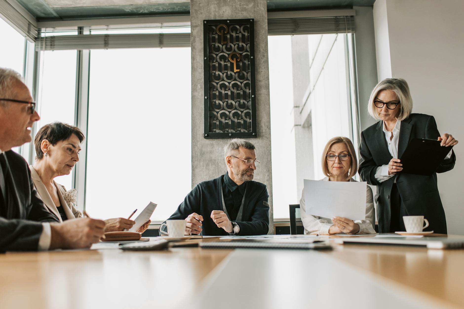 Professional business meeting in modern boardroom setting