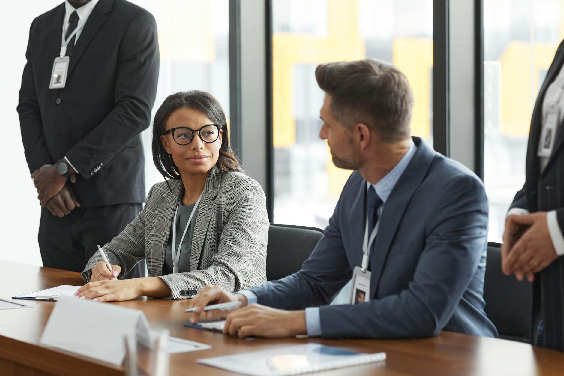 Professional business meeting with executives discussing technology strategy around conference table