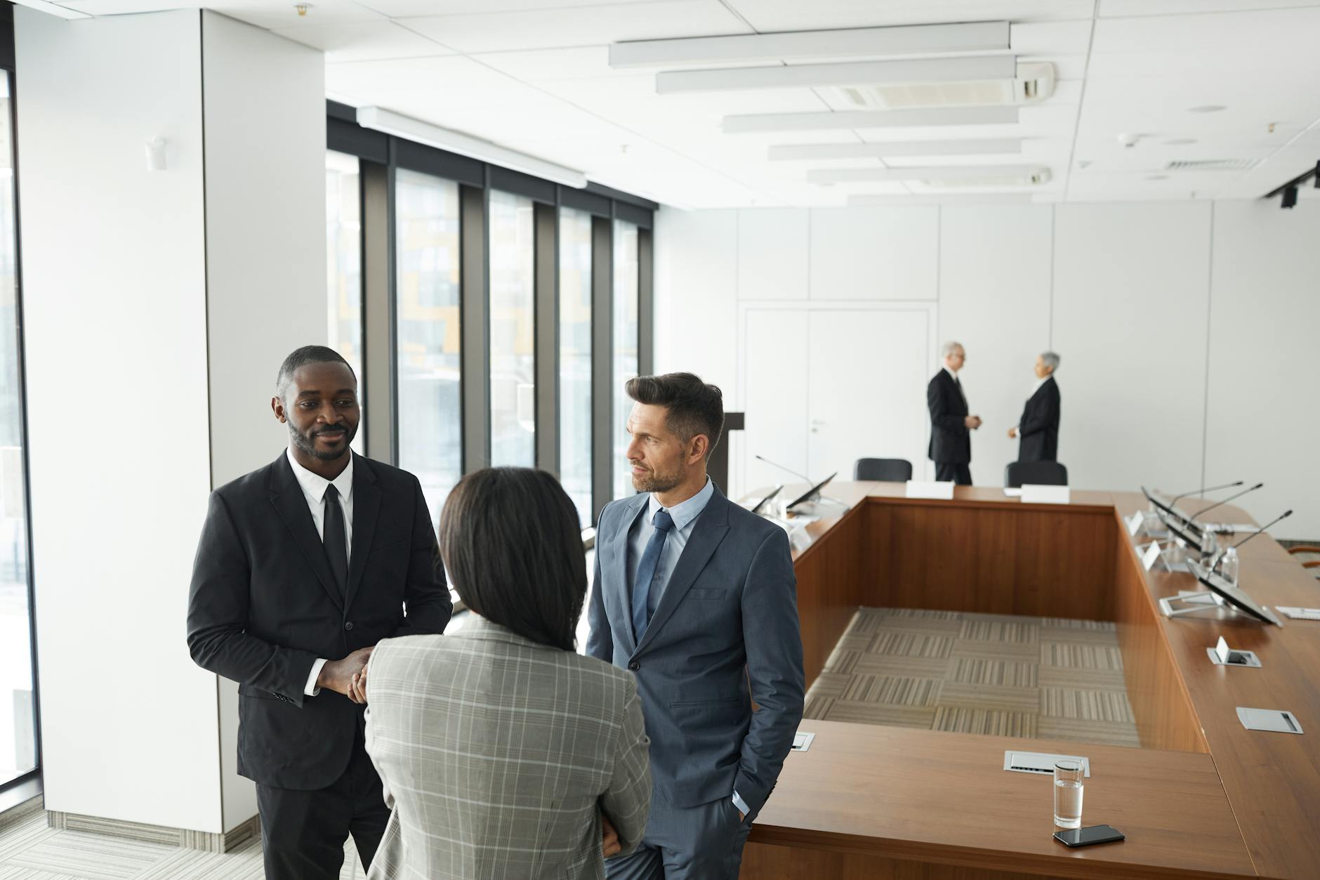Corporate executives discussing strategy around conference table