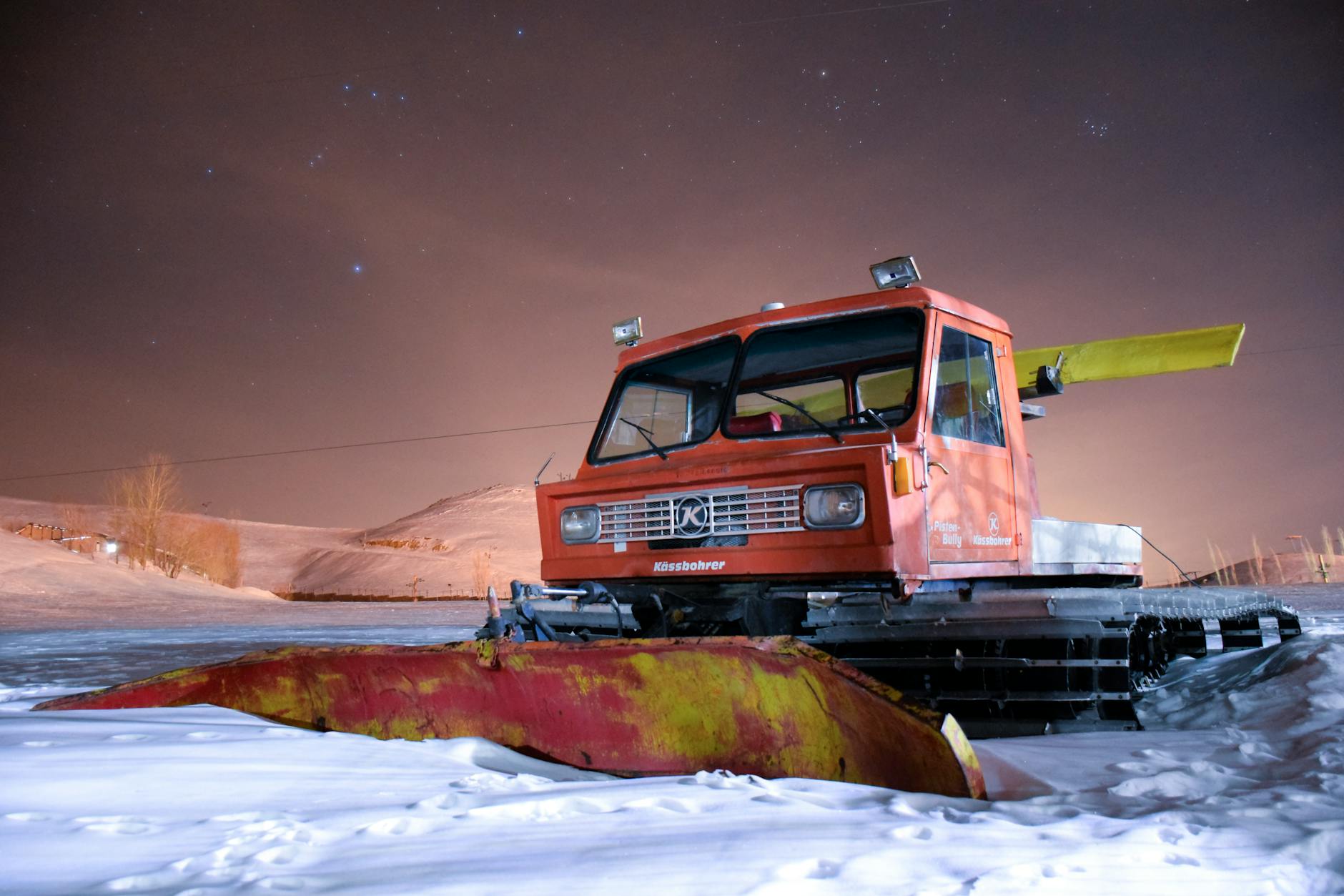 Snow removal equipment and plow truck working to clear roads during heavy snowfall
