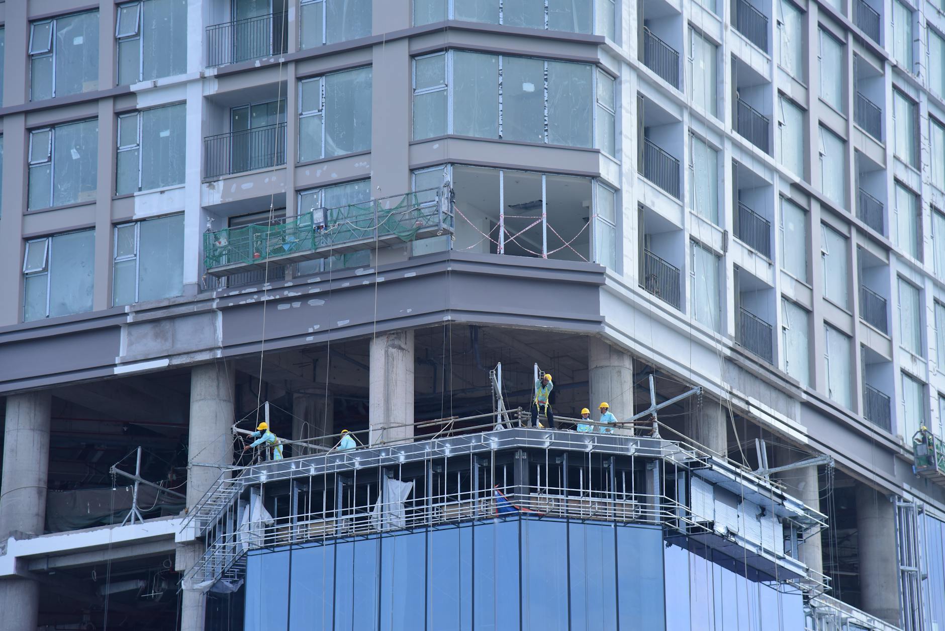 Construction workers rebuilding structures with modern safety equipment