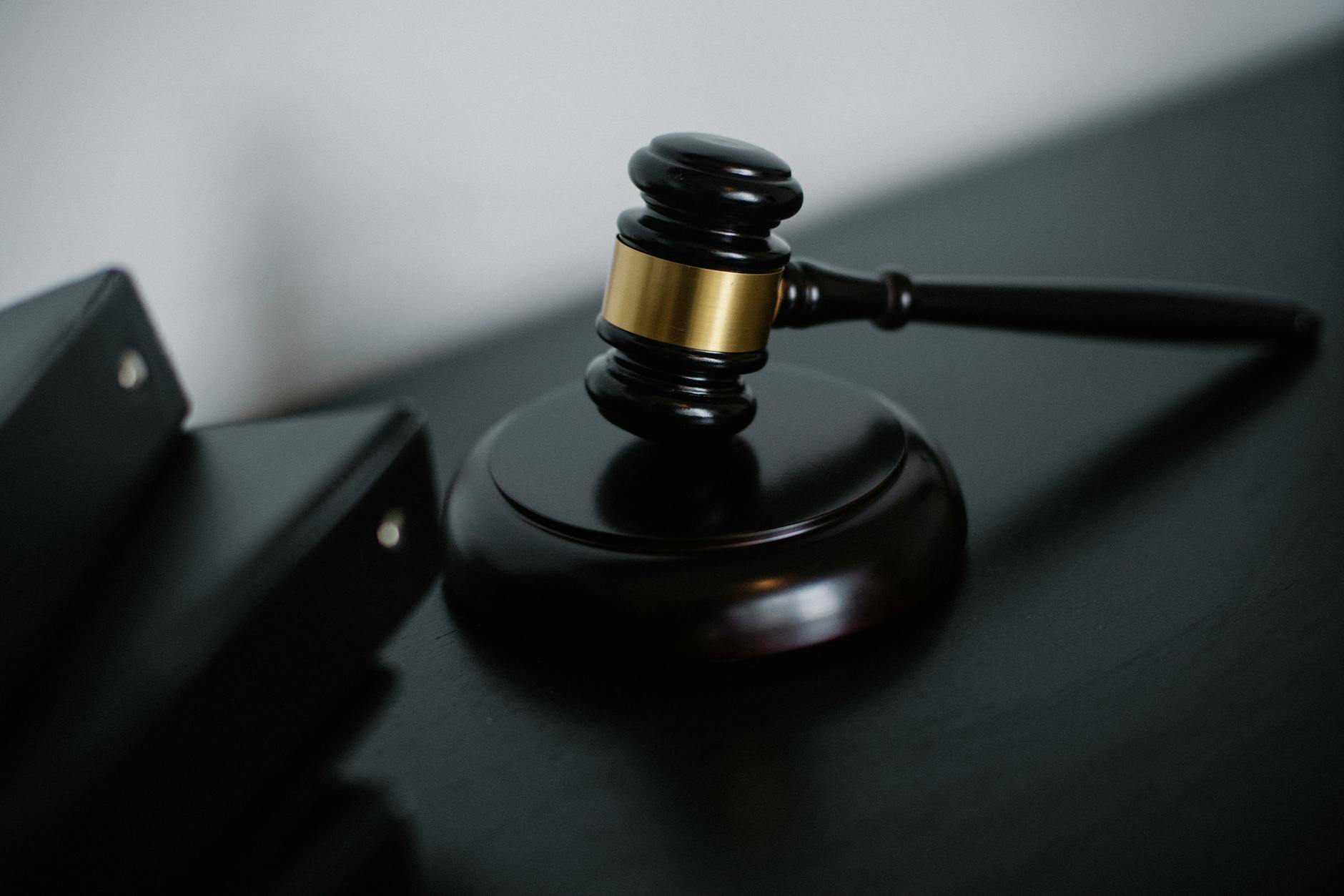 Judge's gavel on wooden desk in courtroom setting