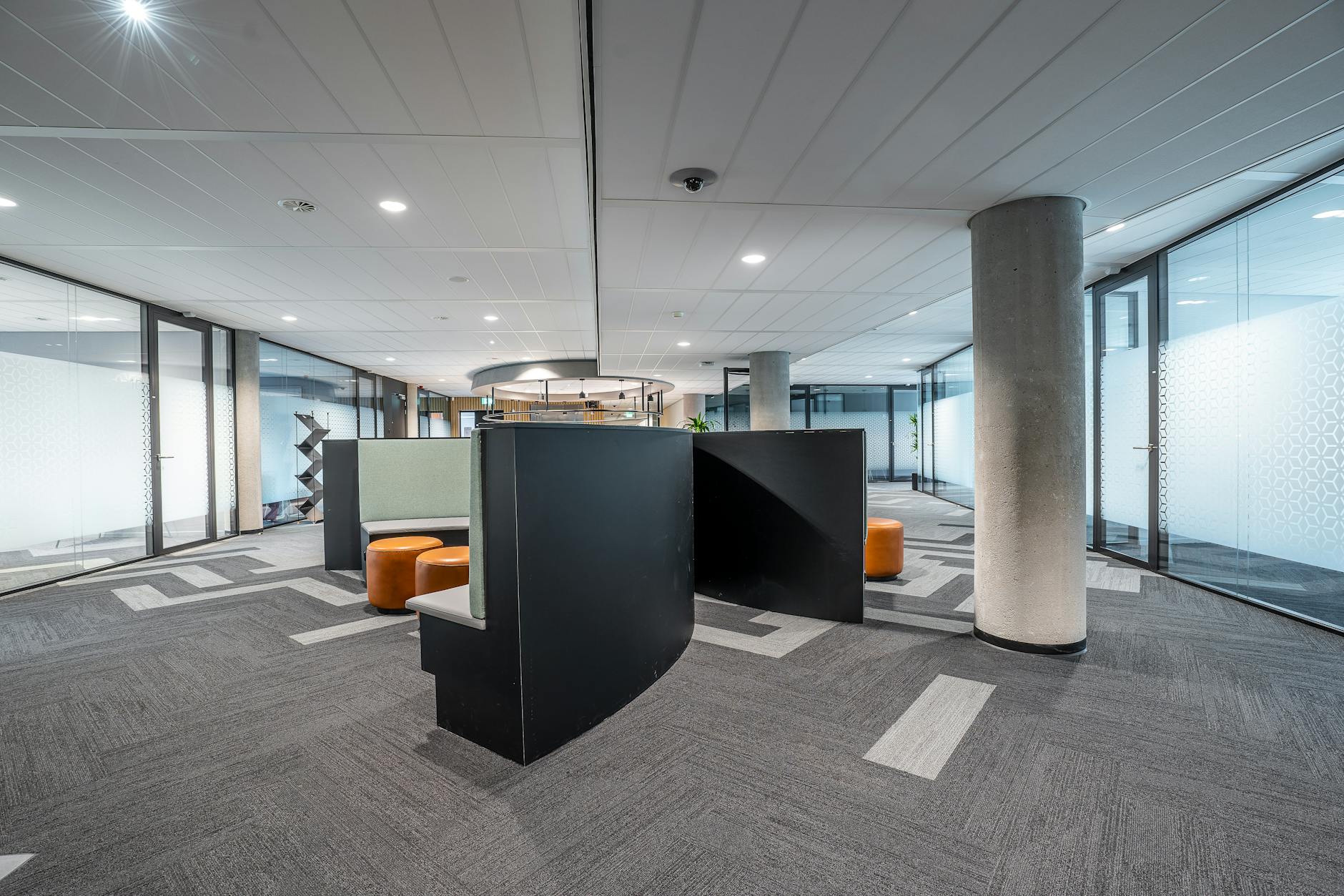 Contemporary bank interior with digital displays and customer service areas