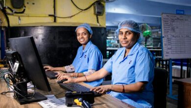 Workers on a smartphone assembly line in a modern manufacturing facility