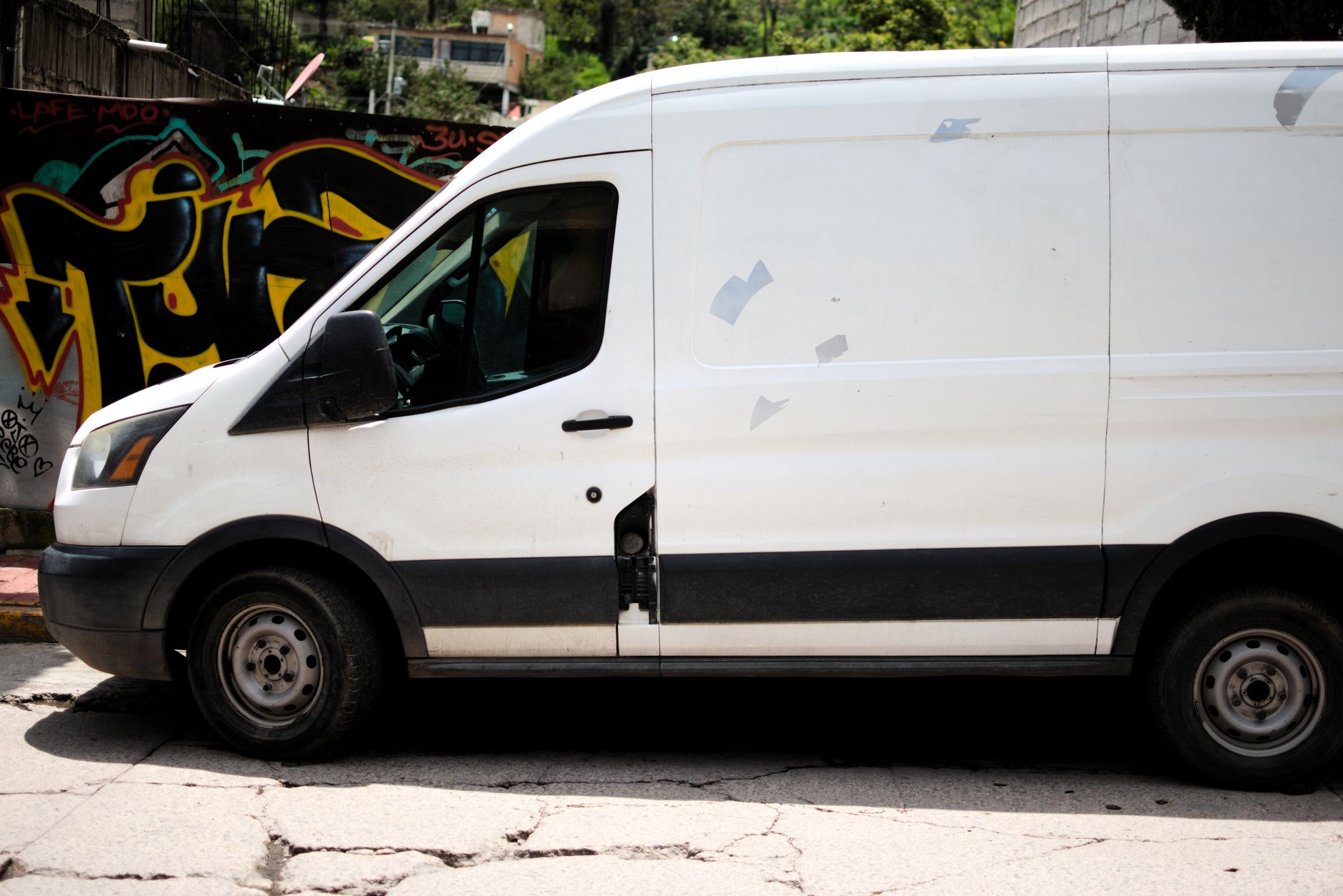A delivery van driving through a busy city street representing same-day delivery logistics