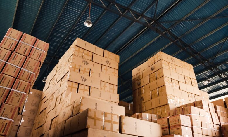 Large warehouse with shelves and logistics operations representing Amazon's marketplace infrastructure