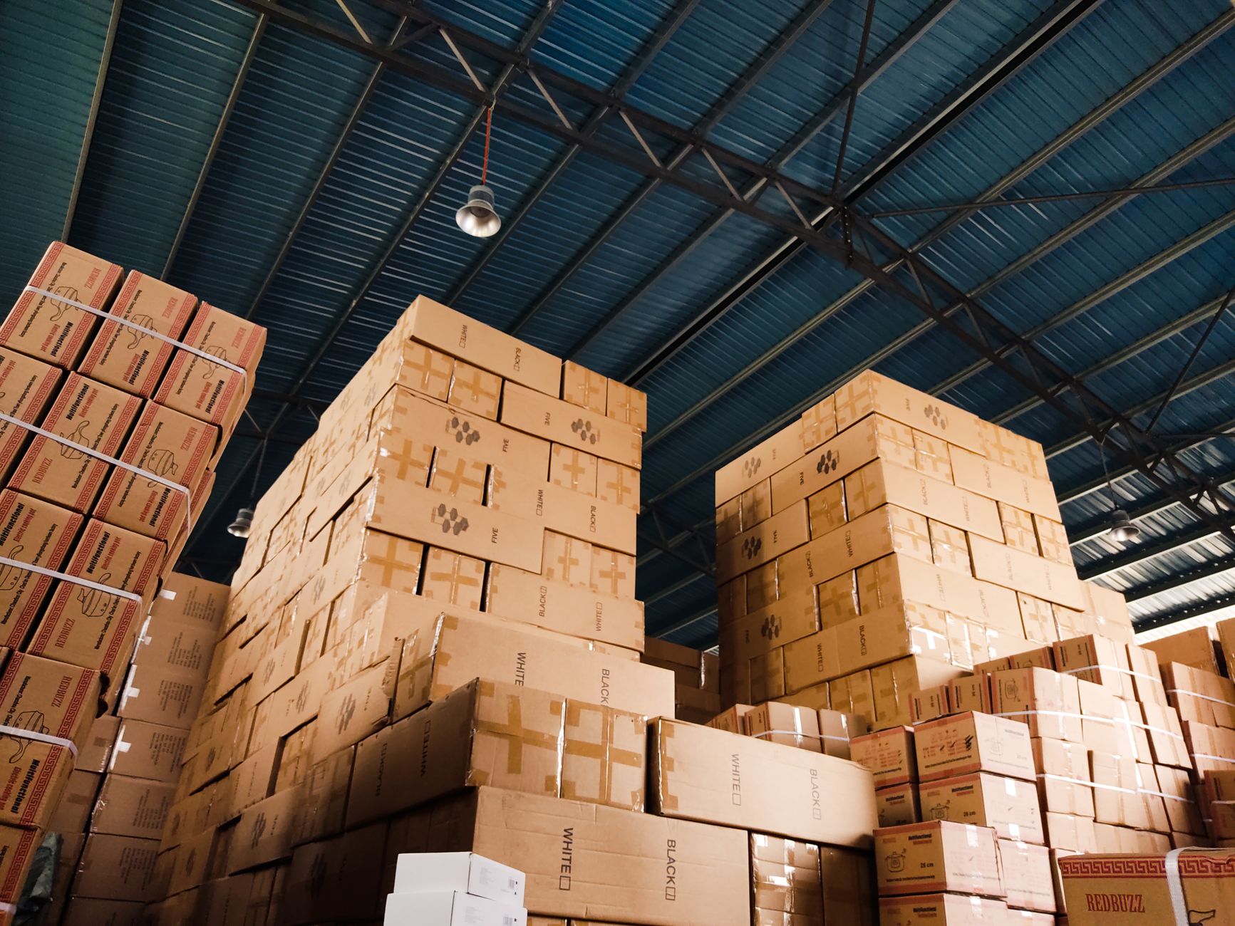 Large warehouse with shelves and logistics operations representing Amazon's marketplace infrastructure