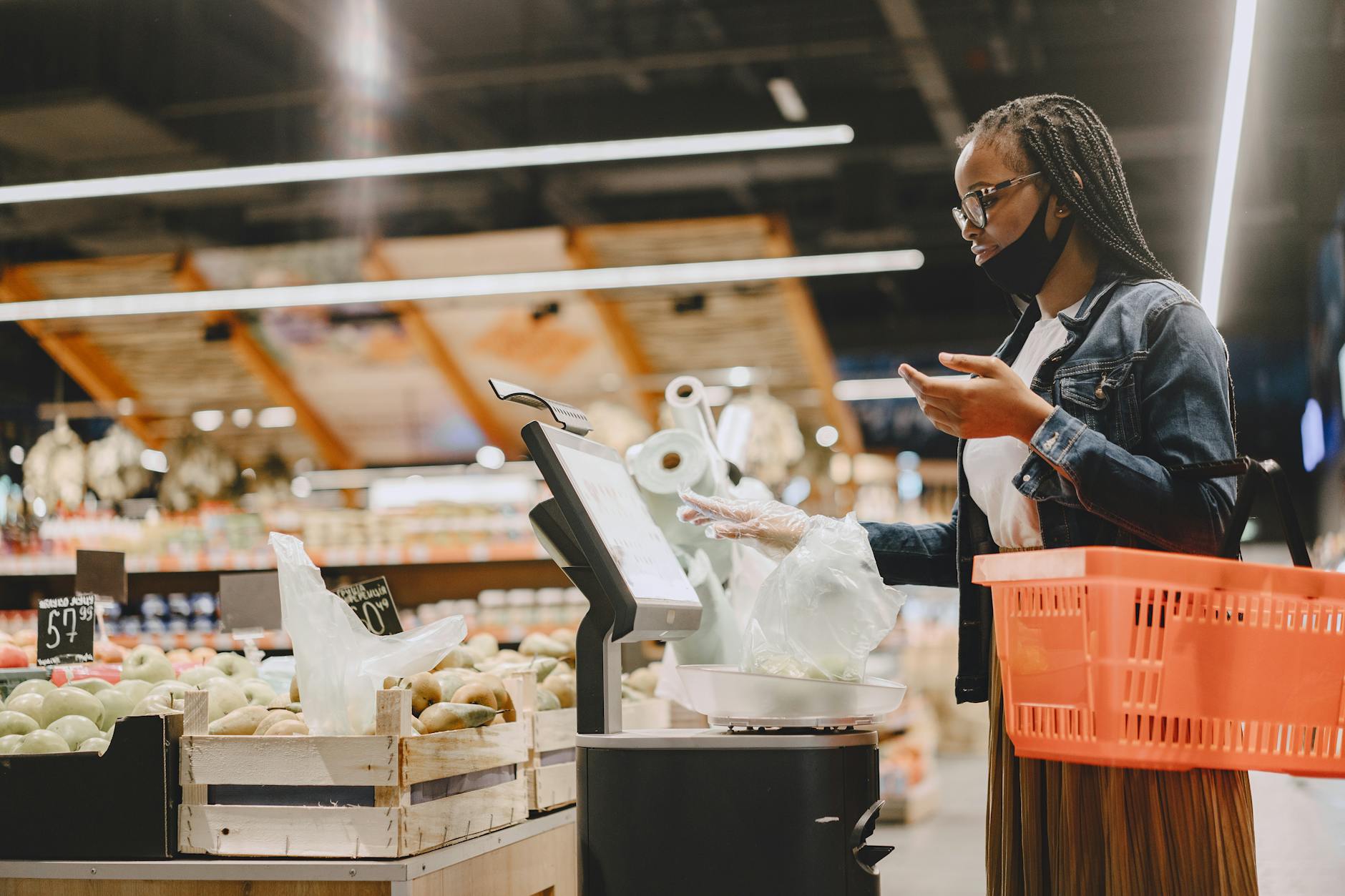 Modern supermarket self-checkout station with digital screen and product scanner