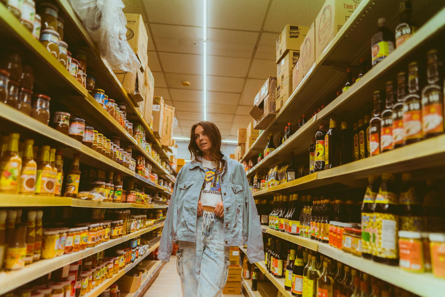 Grocery store aisle lined with store-brand and national-brand products on shelves