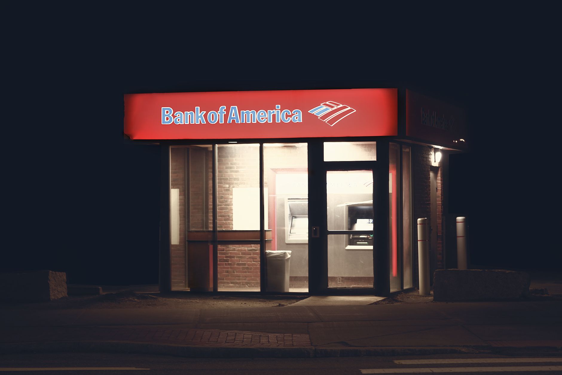 Exterior of a commercial bank branch with glass facade and signage
