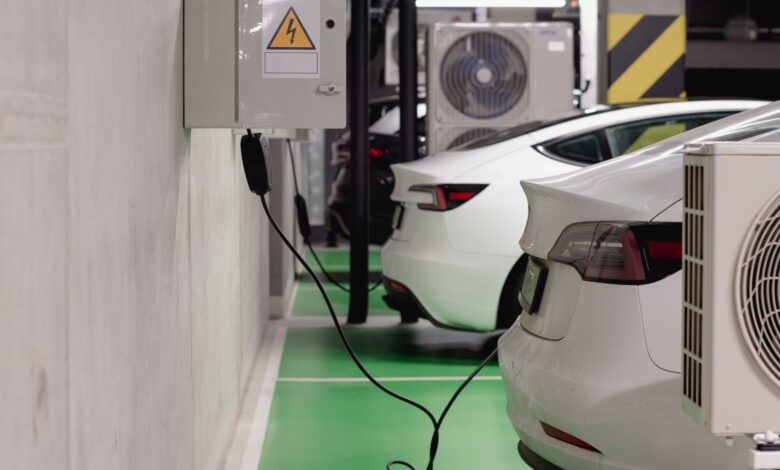 Electric vehicle connected to a charging station in a parking lot