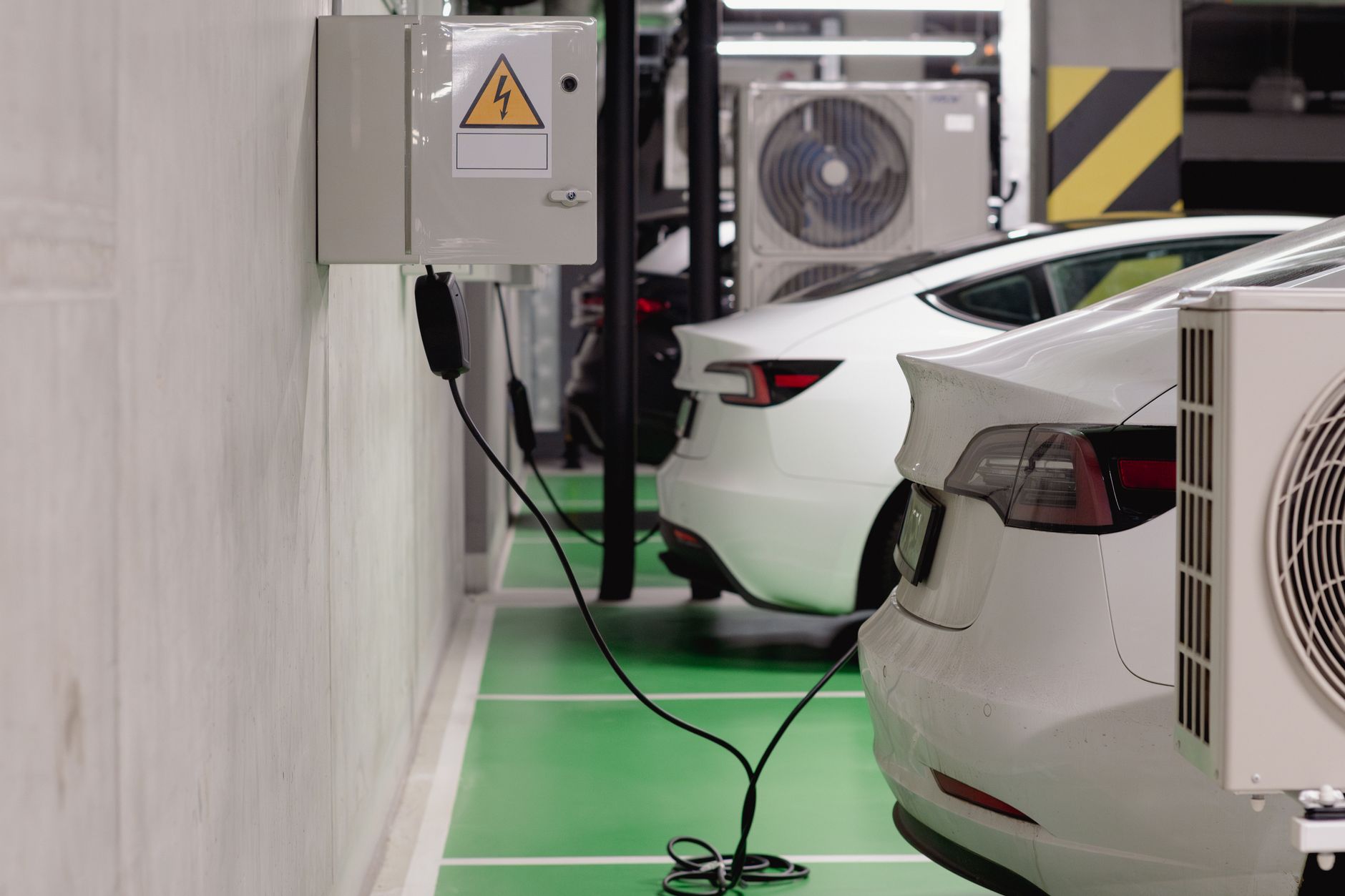 Electric vehicle connected to a charging station in a parking lot