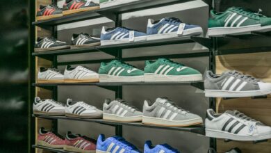 Rows of athletic sneakers displayed on shelves in a retail store