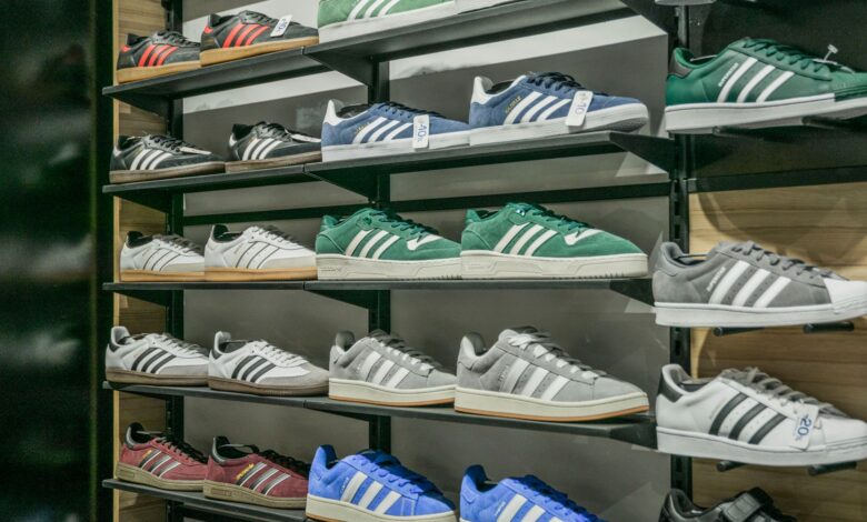 Rows of athletic sneakers displayed on shelves in a retail store