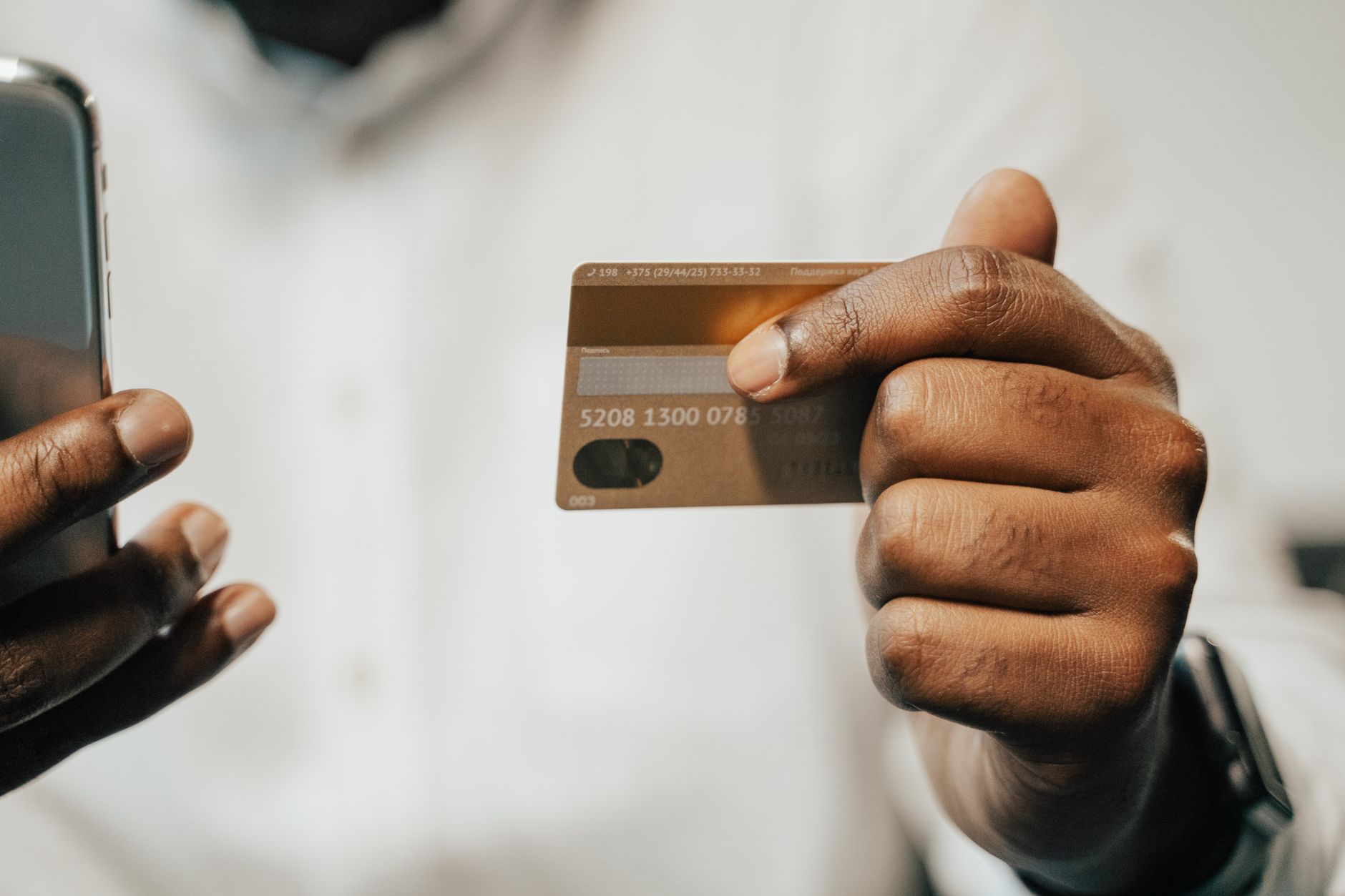 Person using smartphone for digital payment at retail checkout