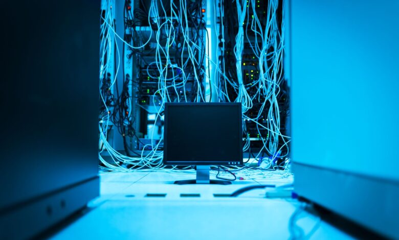 Rows of illuminated servers inside a large data center facility