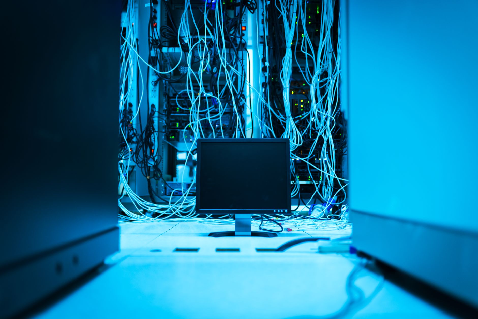 Rows of illuminated servers inside a large data center facility