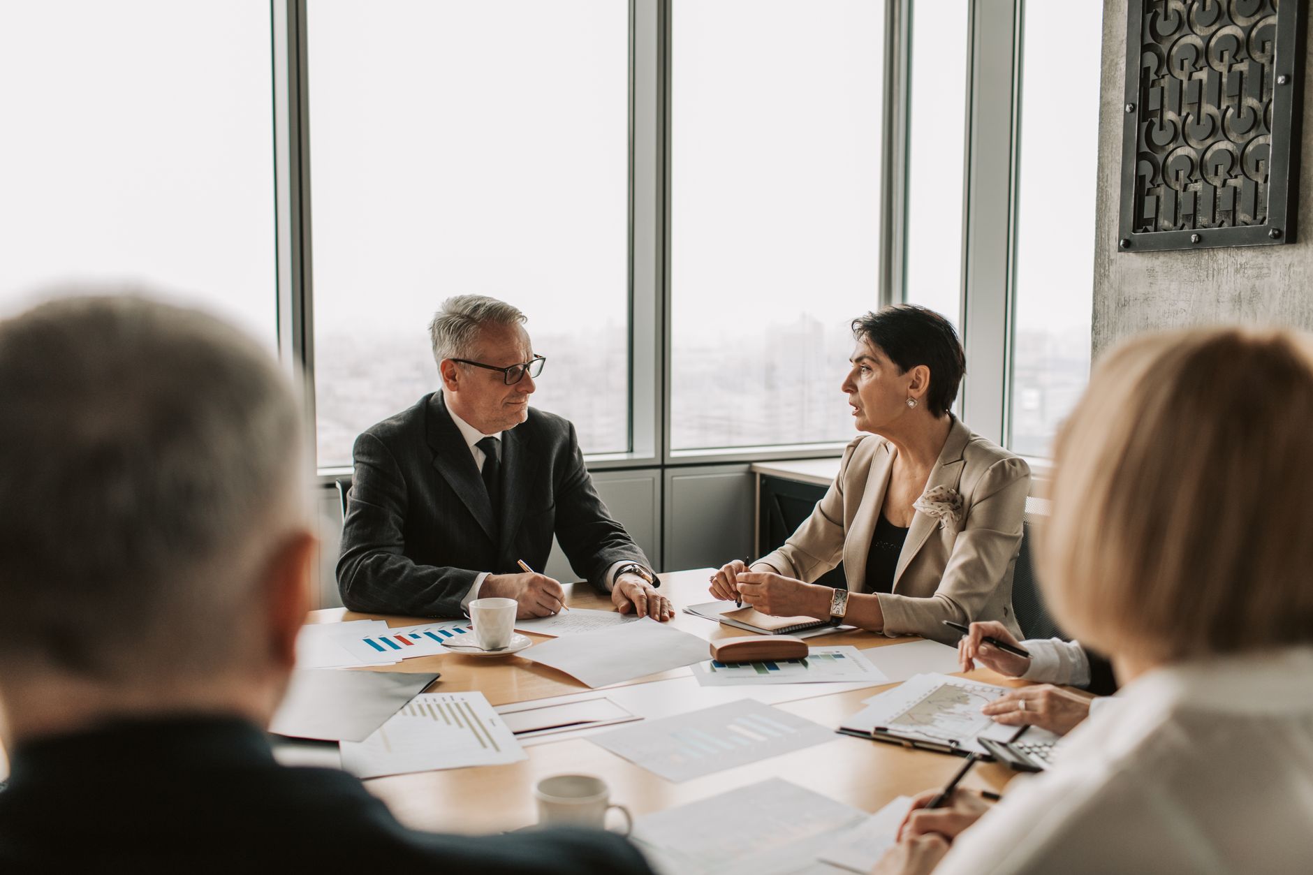 Business executives seated around a conference table during a corporate strategy meeting