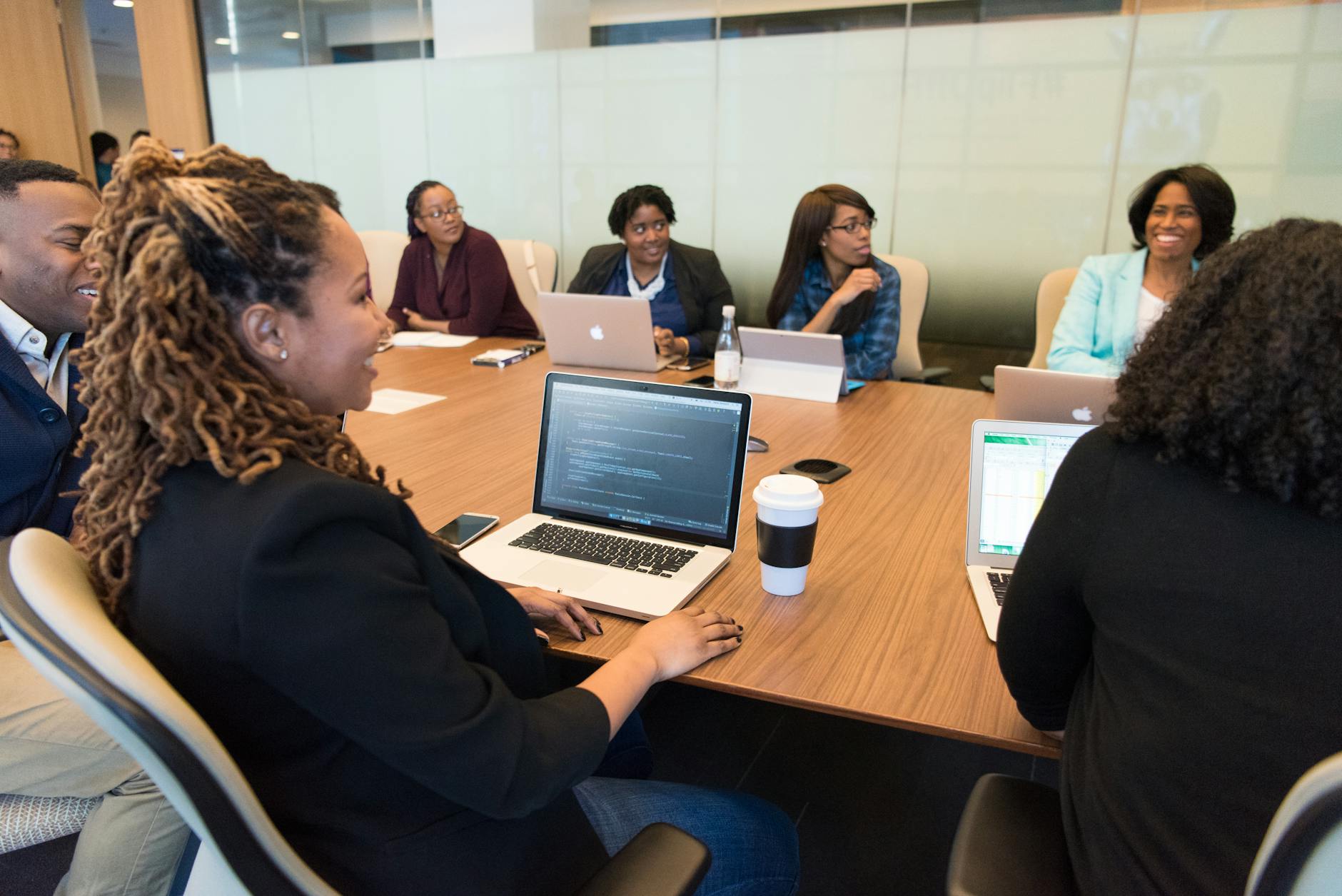 Technology company executives in a formal meeting room discussing strategic decisions