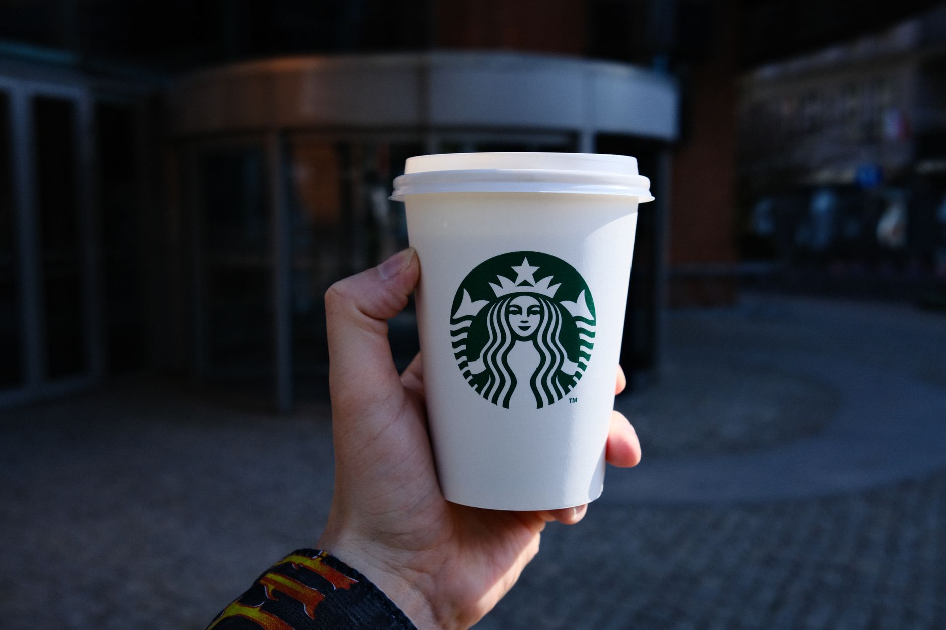 Starbucks barista preparing drinks at a busy coffee counter