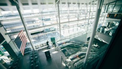 Busy airport terminal with travelers walking through departures hall