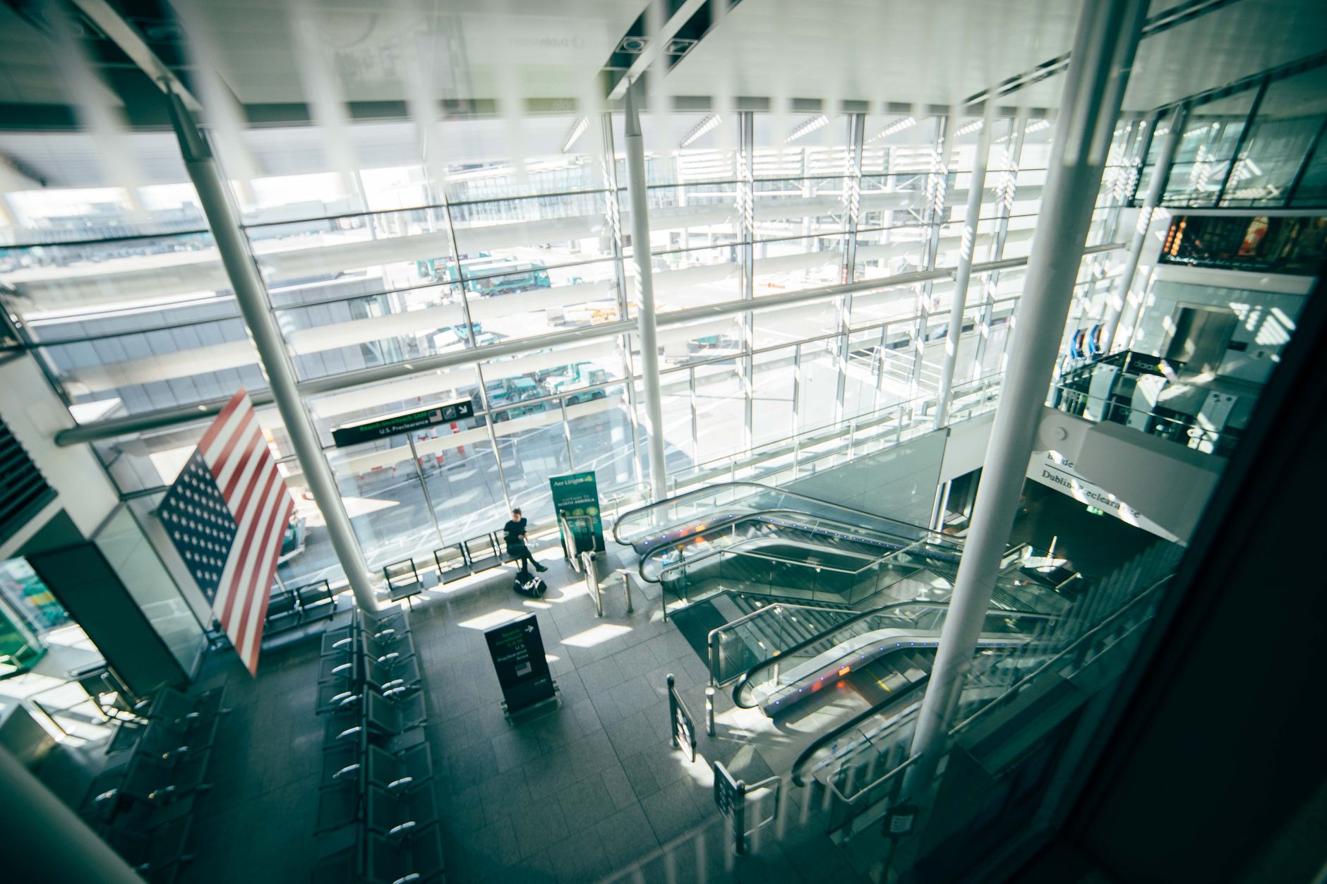 Busy airport terminal with travelers walking through departures hall