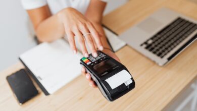 A modern retail payment terminal at a checkout counter ready for contactless use
