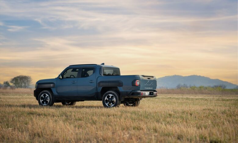 Electric pickup truck charging at an outdoor station