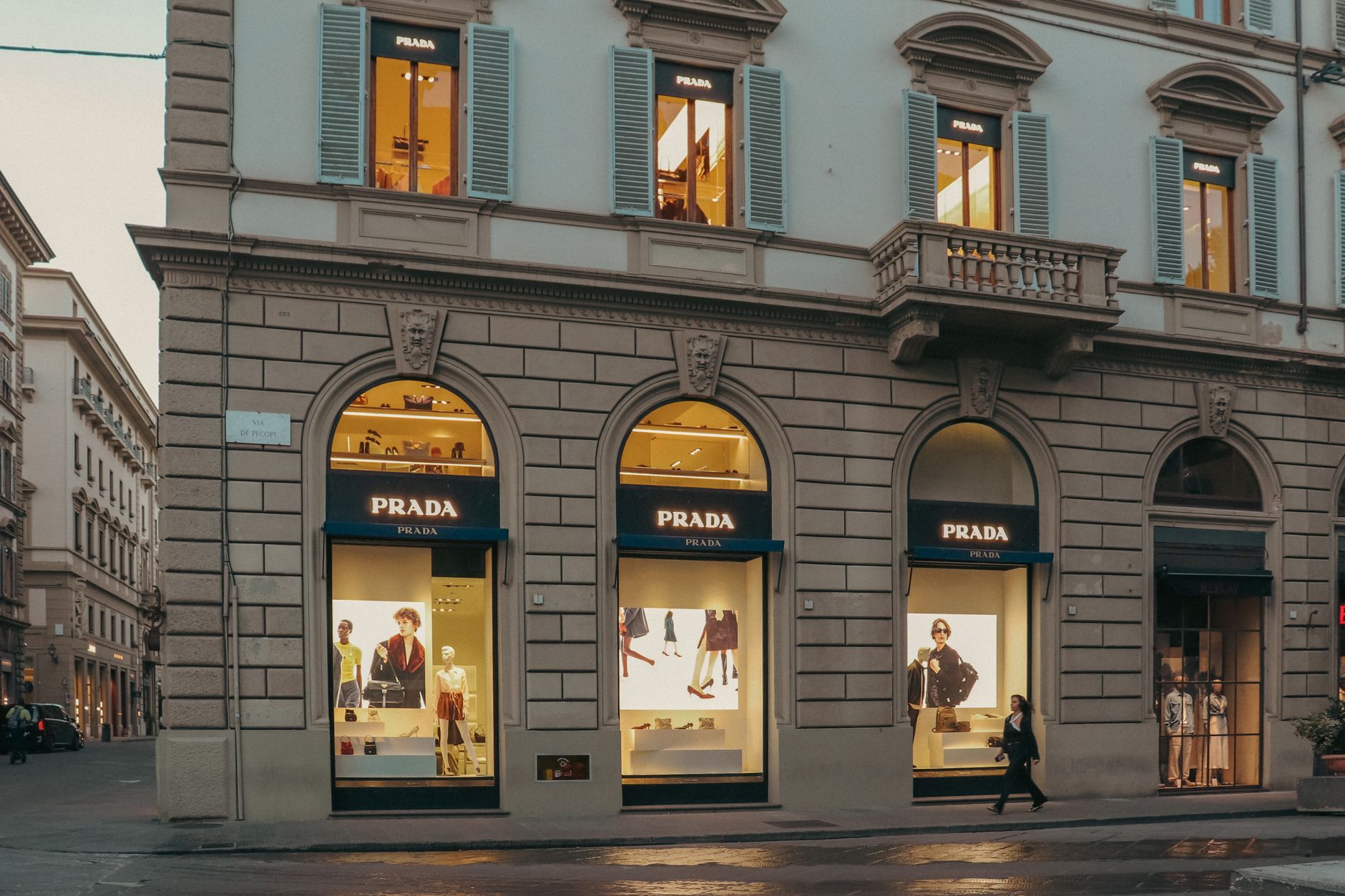 Elegant luxury fashion boutique interior with display cases and soft lighting