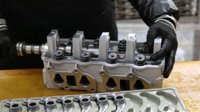 Workers on a modern automotive assembly line producing electric vehicles