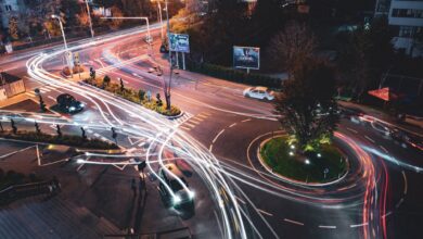 A self-driving vehicle navigating an urban road, representing the robotaxi industry