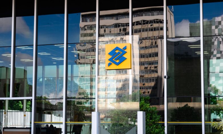 Modern bank branch exterior with glass facade on a city street