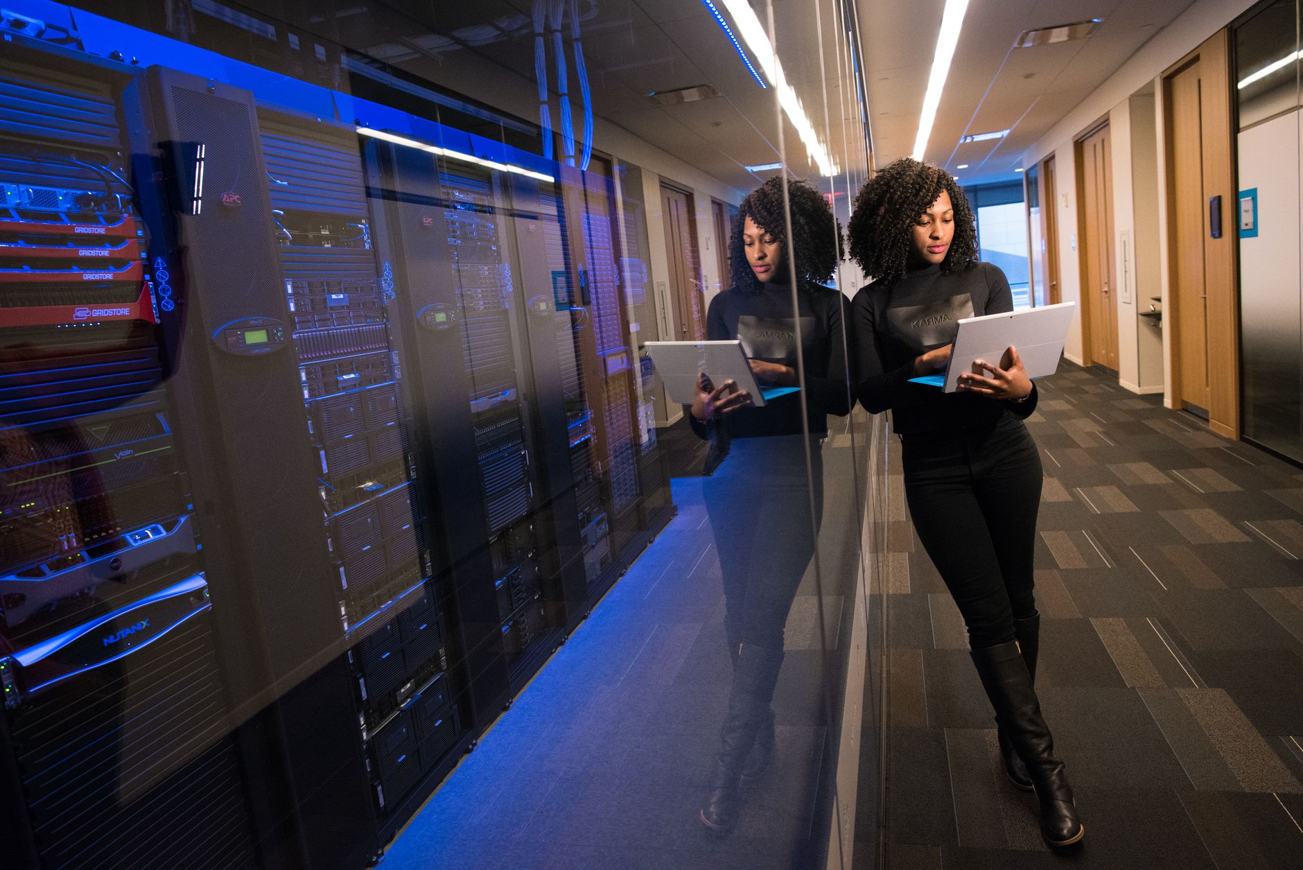 Rows of servers inside a large modern data center facility
