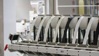 Workers on a modern electronics assembly line representing iPhone manufacturing operations