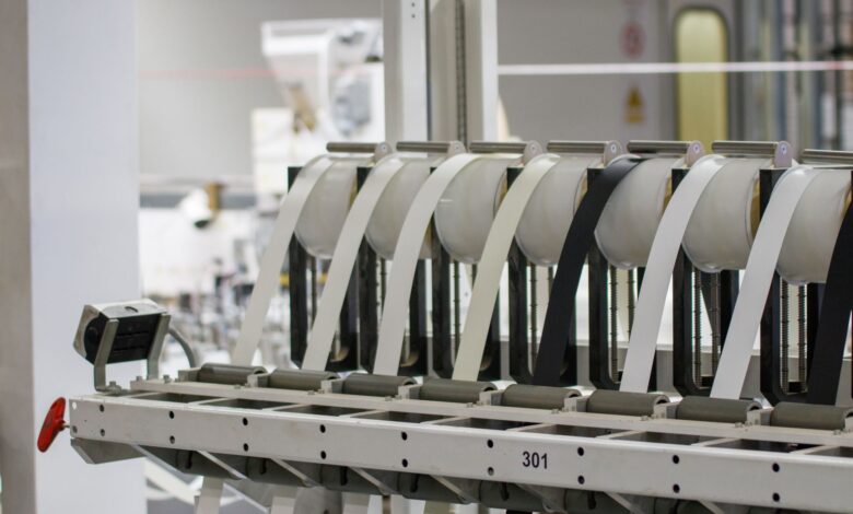 Workers on a modern electronics assembly line representing iPhone manufacturing operations