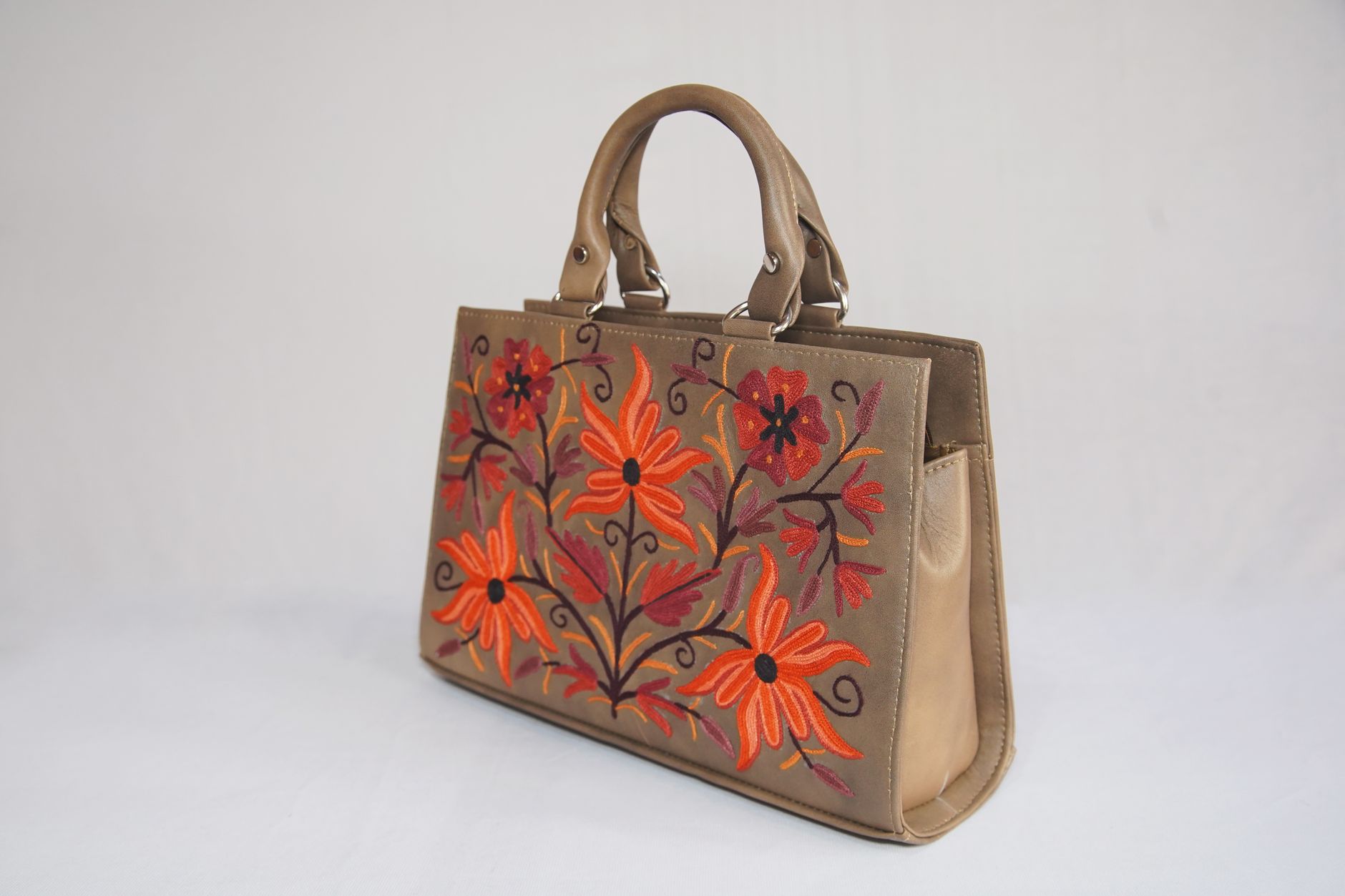 Close-up of a classic quilted designer handbag on a neutral background
