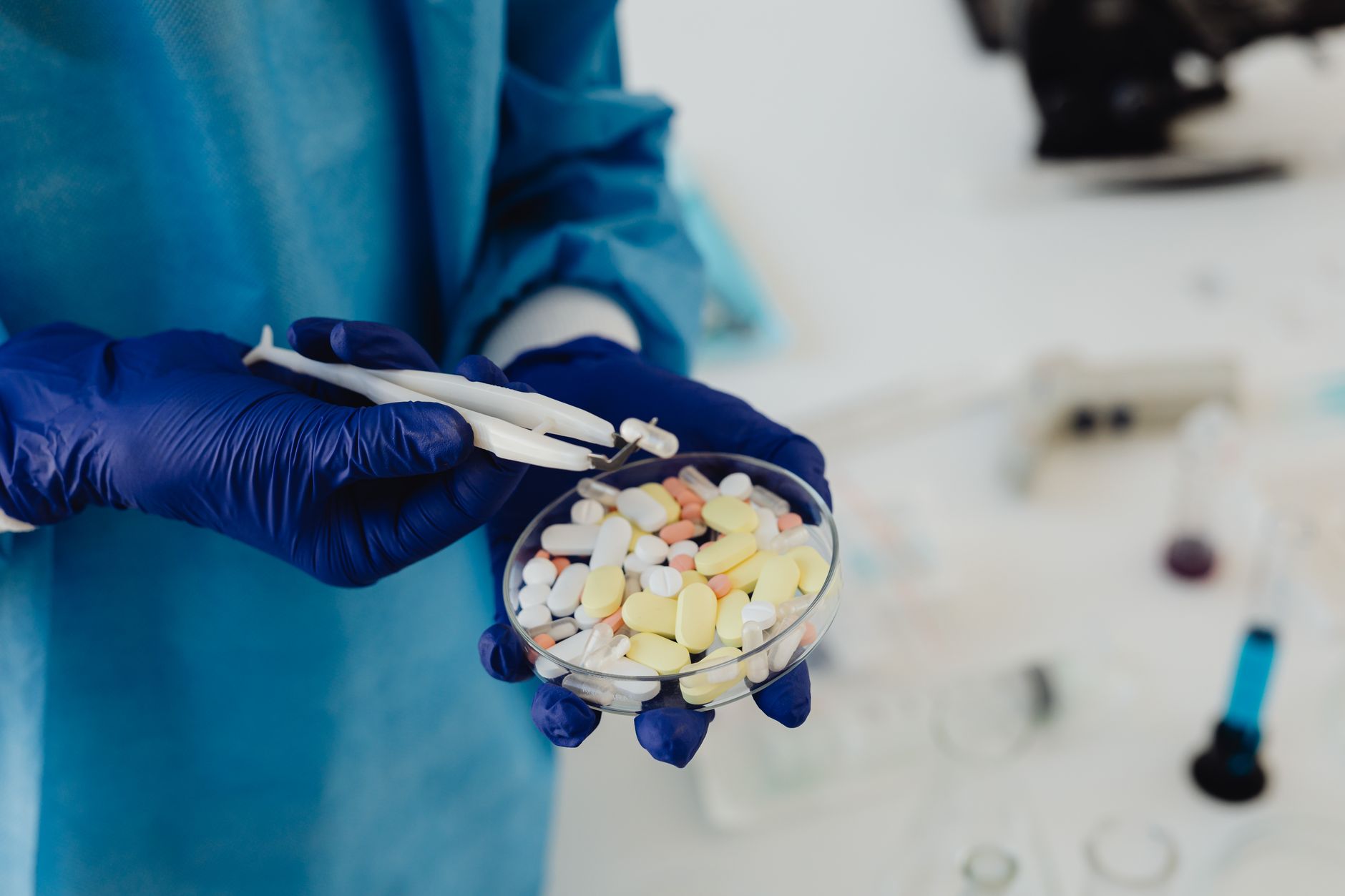 Close-up of prescription medicine pills and laboratory equipment on a research table