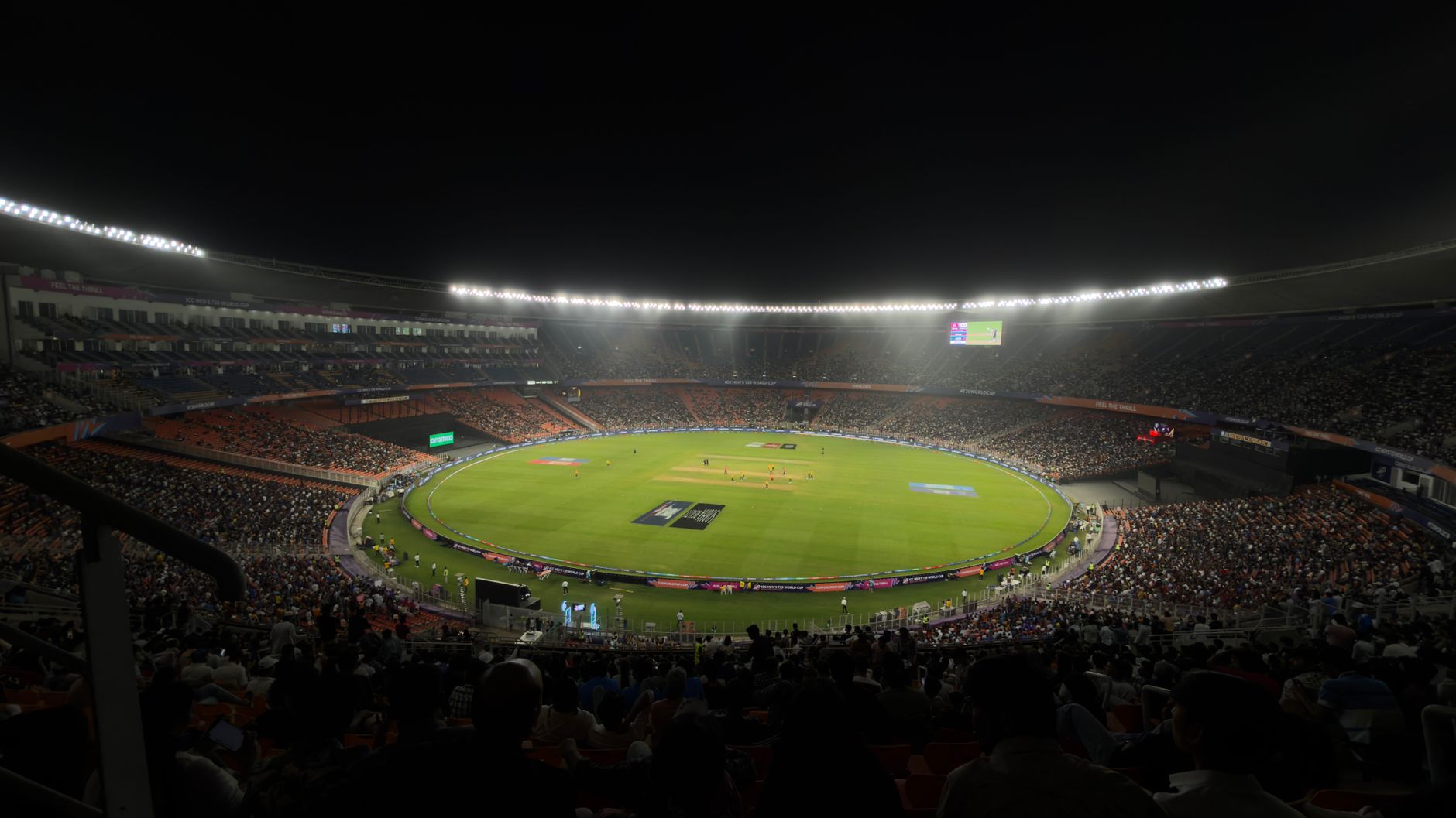 Packed stadium during a live sports event with bright arena lighting