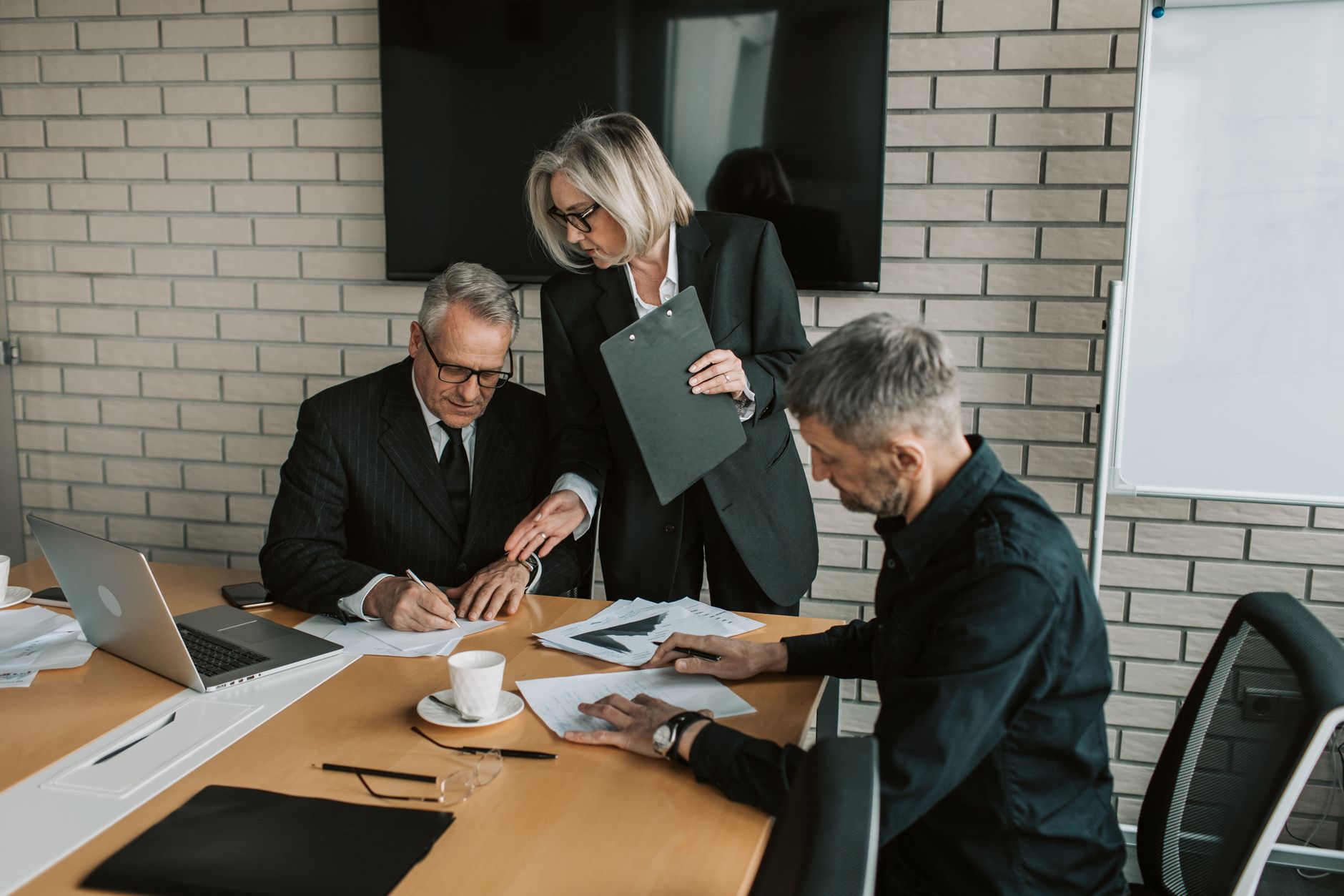 Business professionals in a boardroom meeting discussing technology procurement decisions